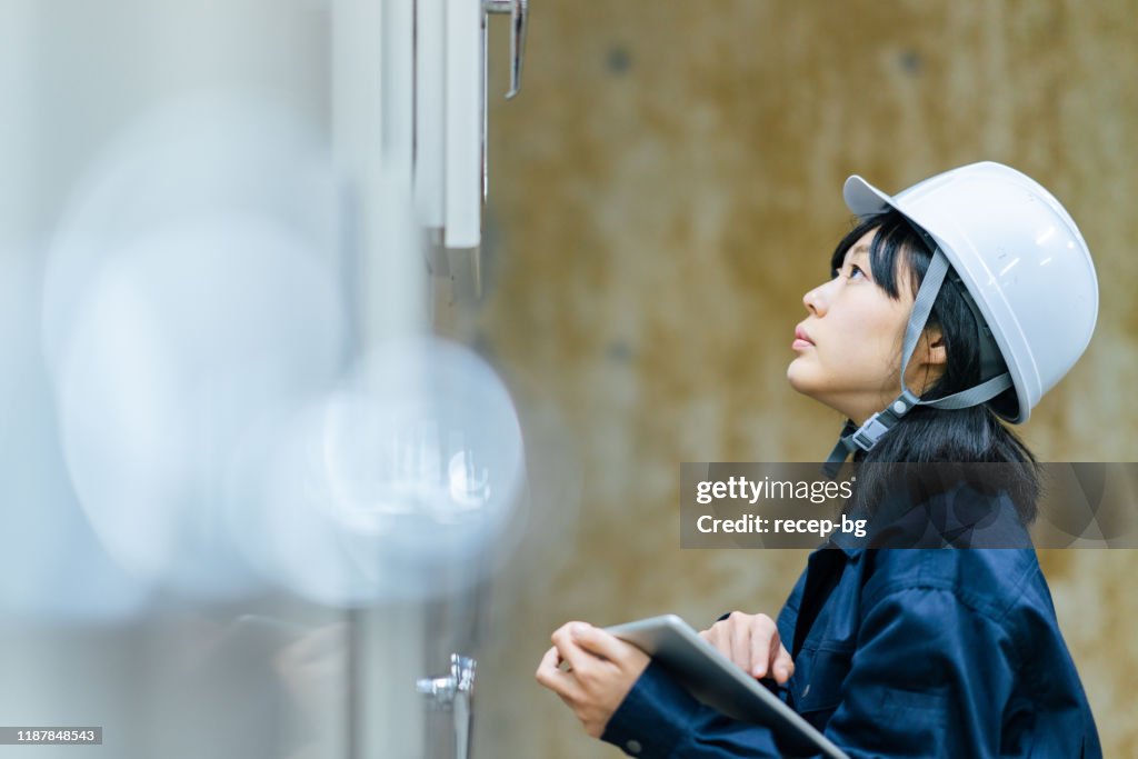 Young female engineer working at engineering facility