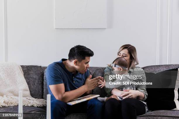 cheerful dad plays with adorable baby girl - clapping game stock pictures, royalty-free photos & images