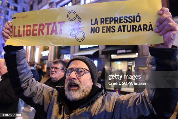 Catalonia pro independence demonstrator holds a placard during the protest. Hundreds of people gathered at Callao square in Madrid to mark the...