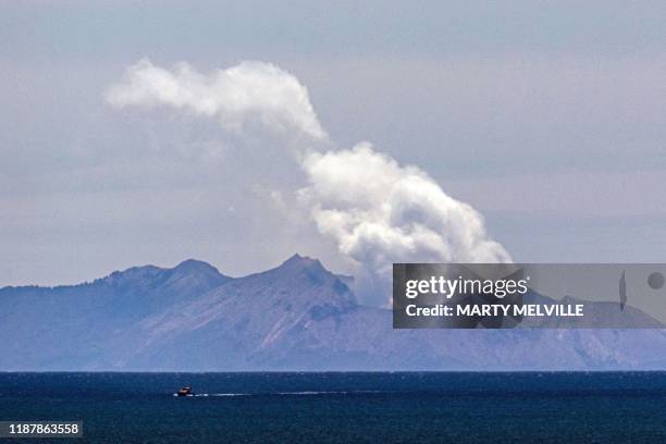 Steam rises from the White Island volcano following the December 9 volcanic eruption, in Whakatane on December 11, 2019. - The smouldering New...