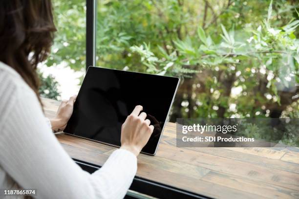 woman using digital tablet - blank screen stock pictures, royalty-free photos & images