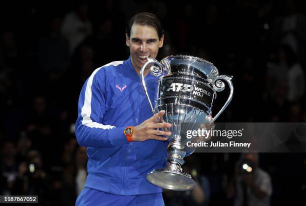 Rafael Nadal of Spain poses with his trophy after being announced as ATP Tour end of year world number one following his singles match against...