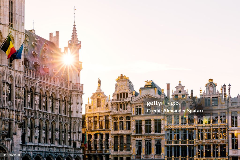 Sun shining through historic buildings at Grand Place in Brussels, Belgium