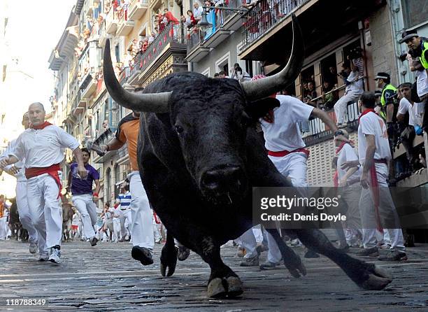 Fighting bull goes around Estafeta corner on the sixth day of the San Fermin running-of-the-bulls on July 11, 2011 in Pamplona, Spain. Pamplona's...