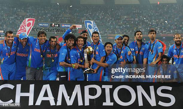 Indian cricketers pose with the trophy after victory in the Cricket World Cup 2011 final over Sri Lanka at The Wankhede Stadium in Mumbai on April 2,...