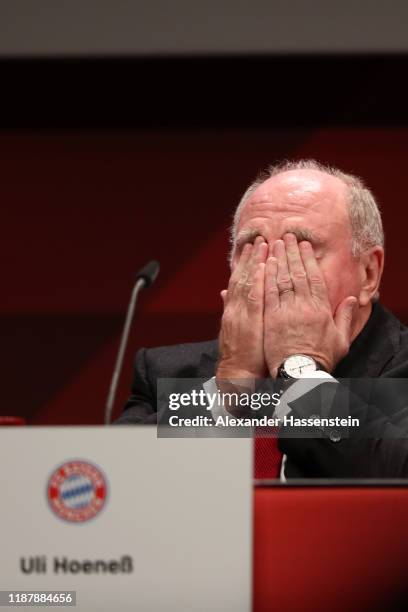 Outgoing Bayern Muenchen president Uli Hoeness covers his face with his hands during the annual general meeting of FC Bayern Muenchen at Olympiahalle...