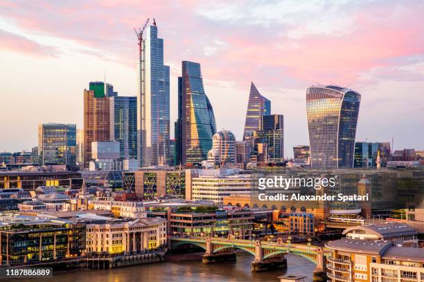 high angle view of skyscrapers in city of london at sunset, endland, uk - london stock-fotos und bilder