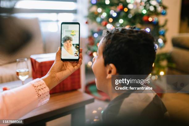 family video conference with grand mother for christmas - mexican christmas stock pictures, royalty-free photos & images