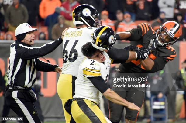 Defensive end Myles Garrett of the Cleveland Browns hits Quarterback Mason Rudolph of the Pittsburgh Steelers over the head with his helmet during...