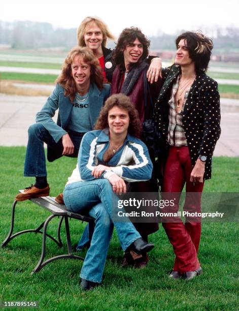 Rock group Aerosmith pose for a portrait on tarmac before boarding a Lear jet at Evansville Regional Airport, Evansville Ohio, November 6, 1977