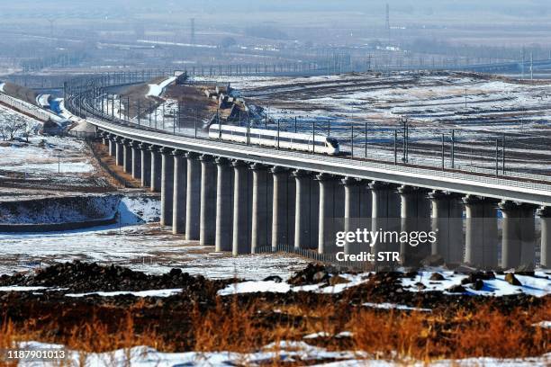 This photo taken on December 9, 2019 shows a bullet train undergoing a test run between Beijing and Hohhot in China's northern Inner Mongolia region....