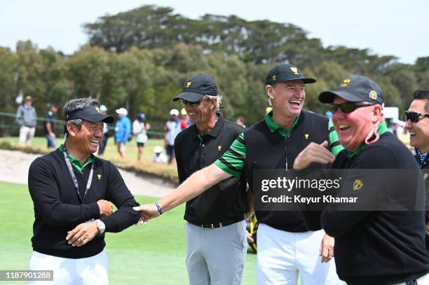 International Team Captains Assistant K.J. Choi of South Korea, caddie Steve Hale and International Team Captain Ernie Els during practice prior to...