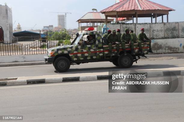 Somali government soldiers on a Military vehicle are seen outside the SYL hotel in Mogadishu on December 11, 2019. - An attack by members of the...