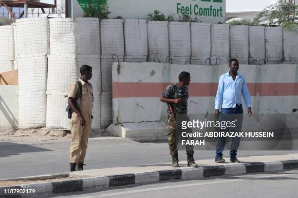 Somali government soldiers seen outside the SYL hotel in Mogadishu on December 11, 2019. - An attack by members of the radical Islamic group Al...