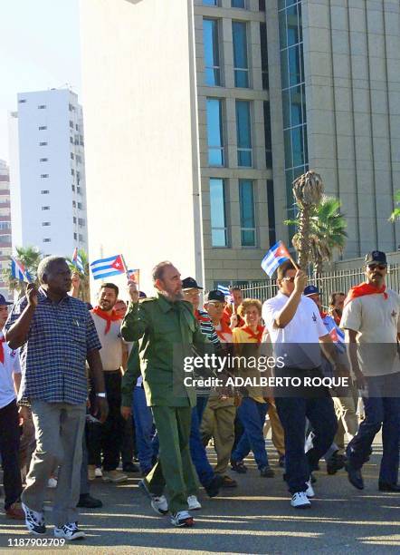 Cuban President Fidel Castro , dressed with his usual uniform, leads thousands of Cubans in a march past the US Interests Section in Havana, Cuba, to...