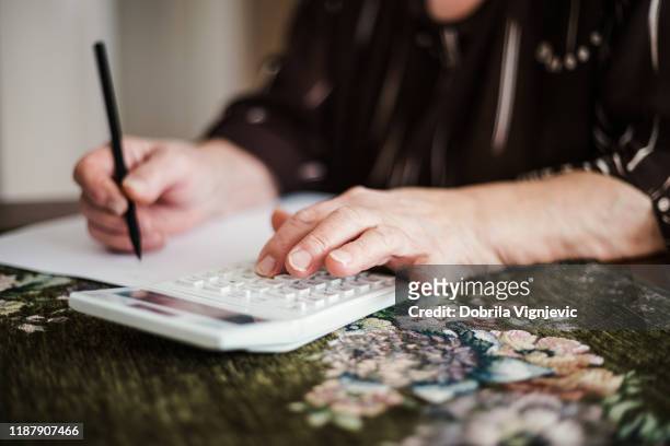 woman doing taxes - vitality stock pictures, royalty-free photos & images