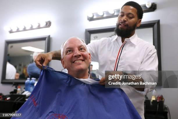 Gov. John Bel Edwards receives a touch up by Daryl Womack, owner of Case Closed Barbershop, on November 15, 2019 in New Orleans, Louisiana. Louisiana...