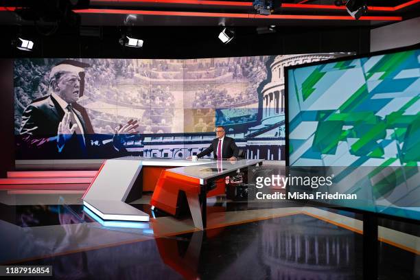 News Presenter Kevin Owen reports a story on the impeachment of US President Donald Trump during an RT broadcast on December 6, 2019 in Moscow,...