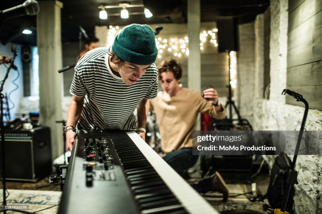 Young musician setting up keyboard