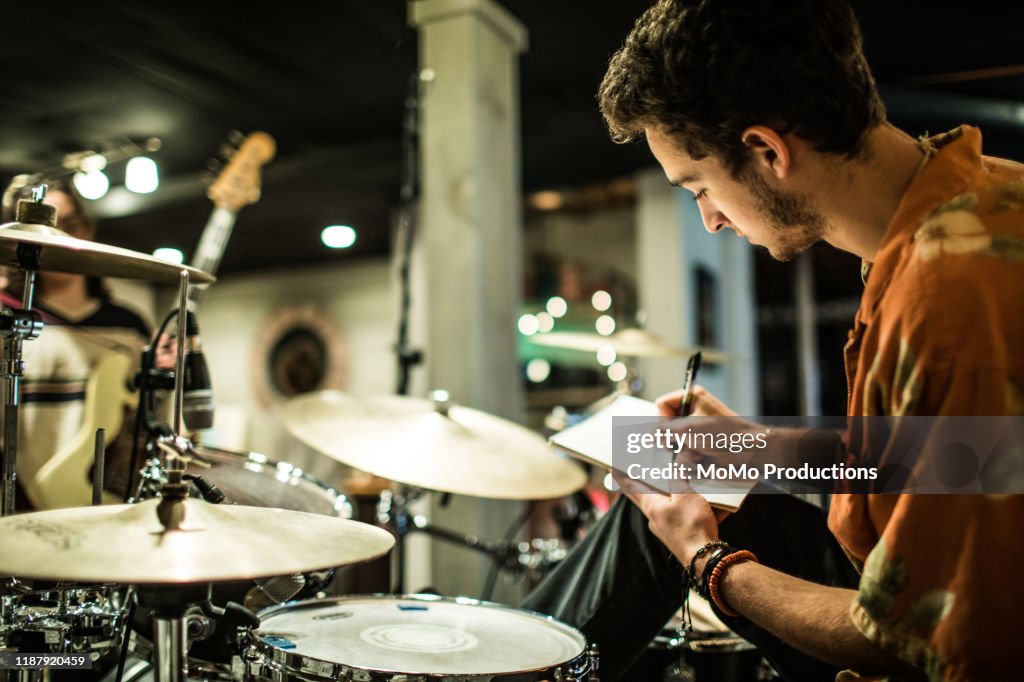 Young rock band writing music together