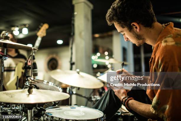 young rock band writing music together - rehearsal studio stock pictures, royalty-free photos & images