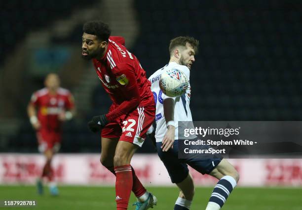 Fulham's Cyrus Christie and Preston North End's Tom Barkhuizen during the Sky Bet Championship match between Preston North End and Fulham at Deepdale...