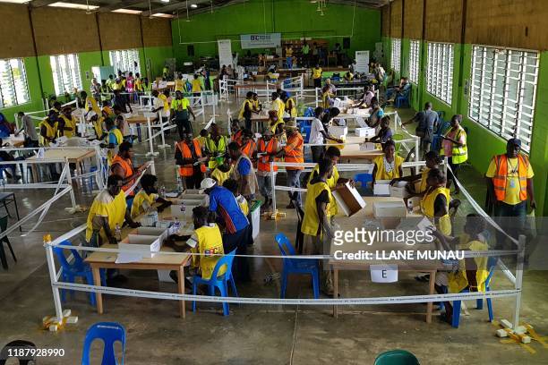 Bougainville Referendum Commission staff count votes prior to the referendum announcement in Bougainville on December 11, 2019. - Voters backing...