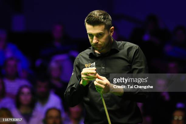 Mark Selby of England chalks the cue during the quarter-final match against John Higgins of Scotland on day five of 2019 Northern Ireland Open at...
