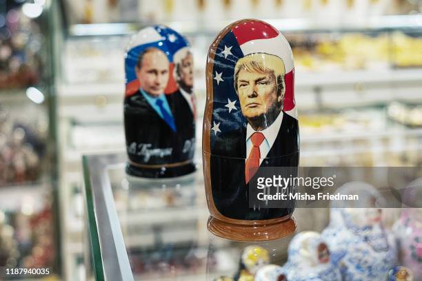 Souvenir shopkeeper displays Matryoshka dolls featuring Russian President Vladimir Putin and US presidents, including Donald Trump, on December 3,...