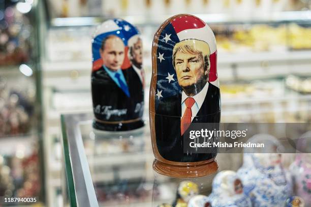 Souvenir shopkeeper displays Matryoshka dolls featuring Russian President Vladimir Putin and US presidents, including Donald Trump, on December 3,...