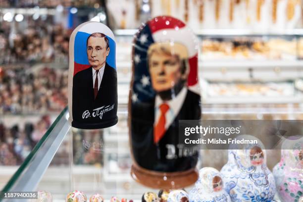 Souvenir shopkeeper displays Matryoshka dolls featuring Russian President Vladimir Putin and US presidents, including Donald Trump, on December 3,...