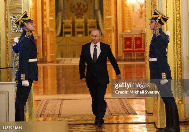 Russian President Vladimir Putin enters the hall during the reception marking the Day of Heroes of the Fatherland at Grand Kremlin Palace on December...