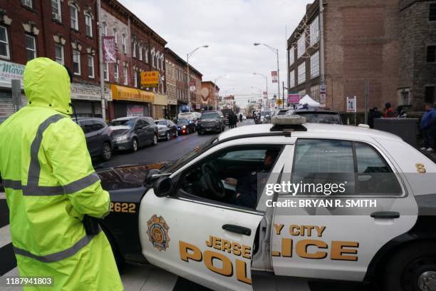 Jersey City Police gather at the scene of the December 10, 2019 shooting at a Jewish Deli on December 11, 2019 in Jersey City, New Jersey. - The...