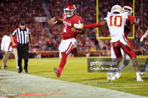 Quarterback Jalen Hurts of the Oklahoma Sooners heads out of bounds at the seven yard line against defensive back Tayvonn Kyle of the Iowa State...