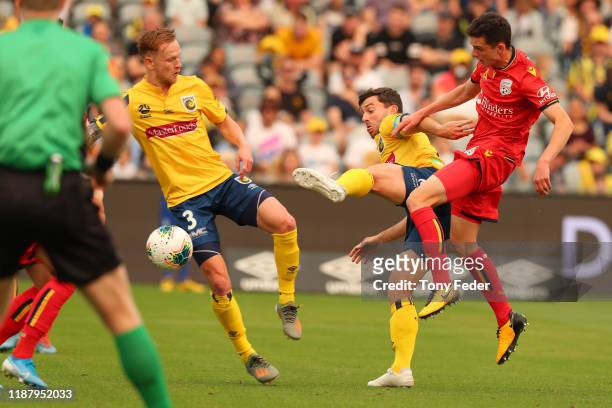 Louis D'Arrigo of Adelaide United contests the ball with Tommy Oar of the Central Coast Mariners during the round 6 A-League match between the...