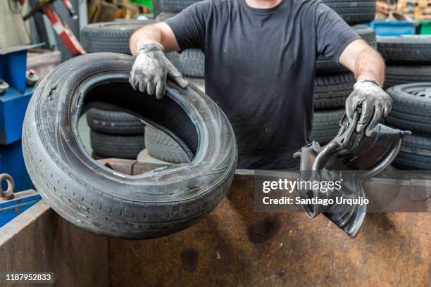 mechanic removing rim from old car tire - obsolete stock pictures, royalty-free photos & images