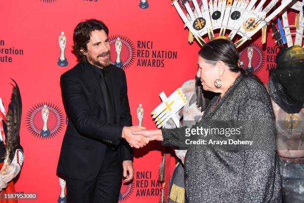 Christian Bale and Sacheen Littlefeather at the 24th RNCI Red Nation International Film Festival and Awards Ceremony on November 15, 2019 in Beverly...