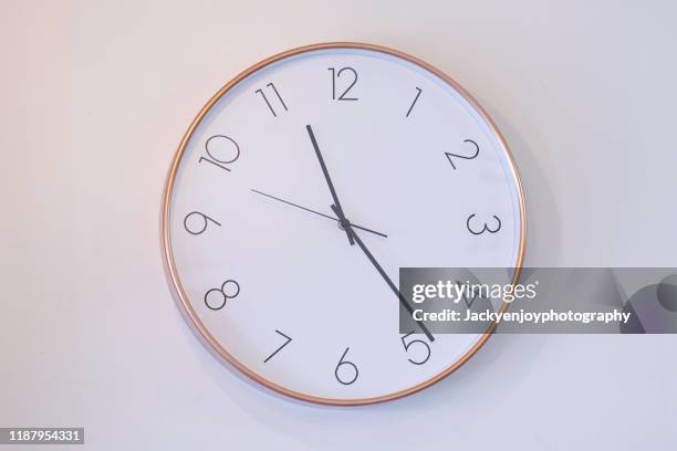 a still life of white clock on the wall"r - reloj de pared fotografías e imágenes de stock