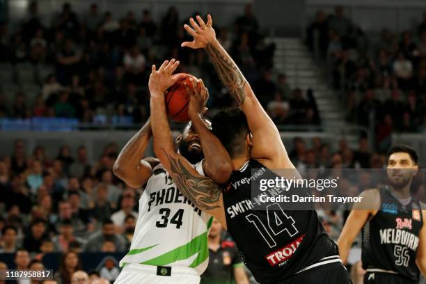 Tohi Smith-Milner of United fouls Keith Benson of the Phoenix during the round seven NBL match between Melbourne United and the South East Melbourne...