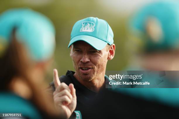 Heat head coach Ashley Noffke talks to players before during the Women's Big Bash League match between the Brisbane Heat and the Sydney Thunder at...