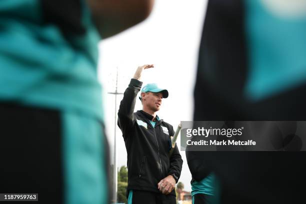 Heat head coach Ashley Noffke talks to players before during the Women's Big Bash League match between the Brisbane Heat and the Sydney Thunder at...