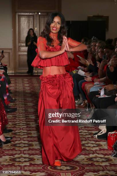Journalist Laurence Roustandjee, dressed by Moira Cristescu, walks the runway during the 3rd "Sauvez Le Coeur Des Femmes - Red Defile" show at Hotel...