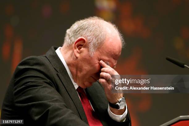 Outgoing Bayern Muenchen president Uli Hoeness reacts during his speech at the annual general meeting of FC Bayern Muenchen at Olympiahalle on...