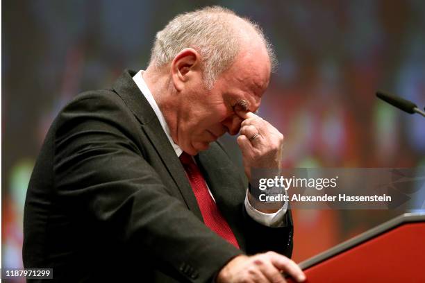 Outgoing Bayern Muenchen president Uli Hoeness reacts during his speech at the annual general meeting of FC Bayern Muenchen at Olympiahalle on...