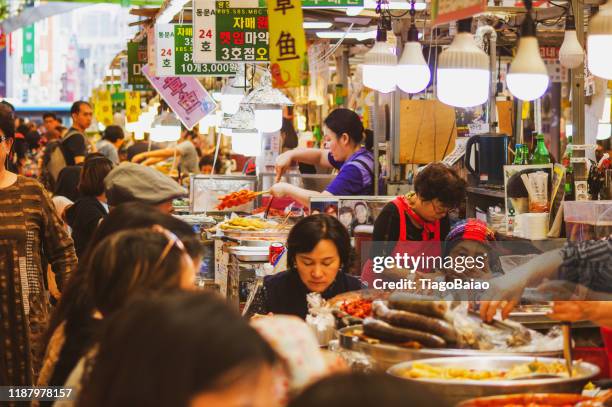 gwangjang life, business owners and customers in a typical lunch time - korea market stock pictures, royalty-free photos & images