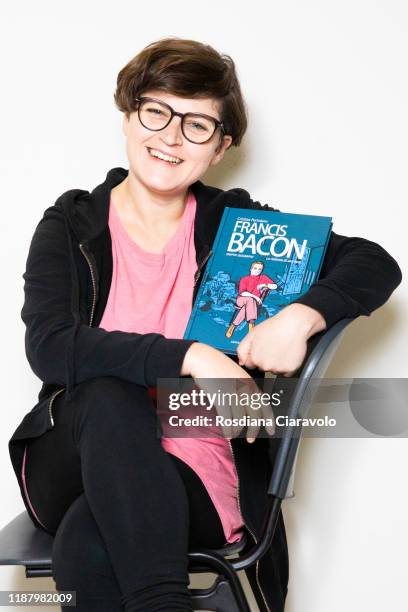 Cartoonist Cristina Portolano poses with her new graphic novel "Francis Bacon. La violenza di una rosa" during the Bookcity Milan 2019 on November...