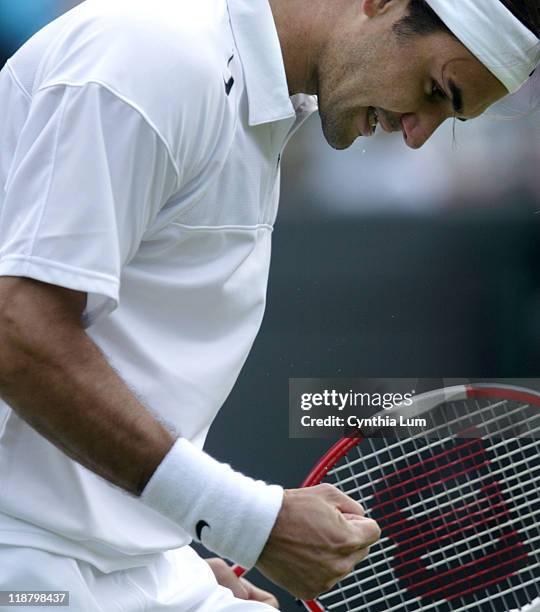 Roger Federer of Switzlerland advances to the quarter finals of Wimbledon Championships with a 6-3, 7-6, 7-6 win over Ivo Karlovic of Croatia in...