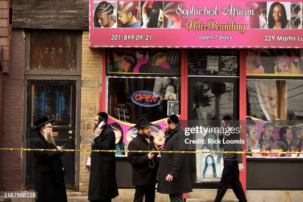 Members of the Jewish community pass by near the scene of a mass shooting at the JC Kosher Supermarket on December 11, 2019 in Jersey City, New...