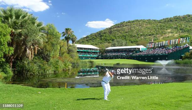 Zander Lombard of South Africa plays his second shot into the 18th green during the third round of the Nedbank Golf Challenge hosted by Gary Player...
