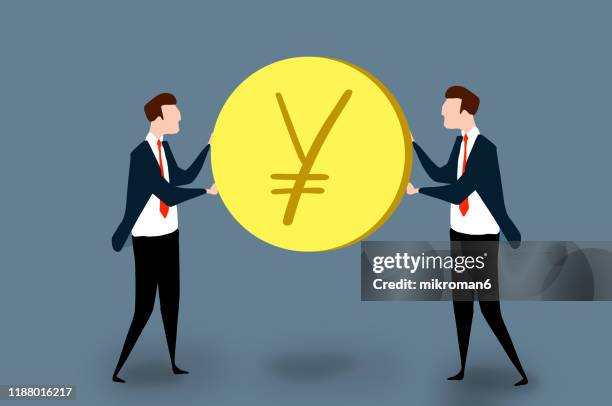 two men in a suit holding a yen coin - yen sign stockfoto's en -beelden